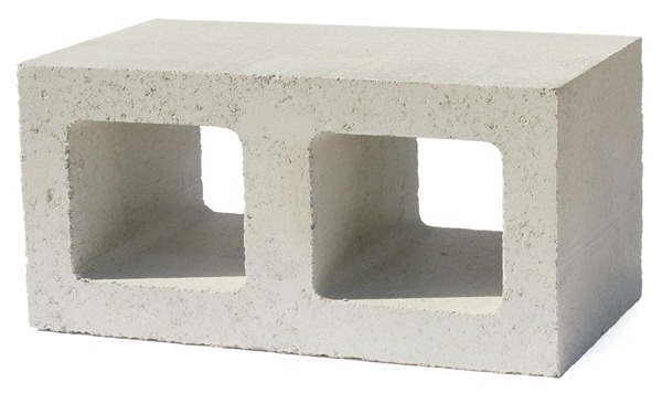  Interior fireplace made of Watershed Block, a new type of structural masonry that uses less cement and incorporates unwashed, locally sourced recycled aggregate. These block were manufactured using a combination of two different regionally sourced aggregates. Varying the ratio between the two in the formulation resulted in the “random mottling” that gives the walls their natural appearance. The architects wisely use the block to encase the wood stove to serve as a heat sink – a thermal flywheel. Image credit: ©Ed Caldwell
