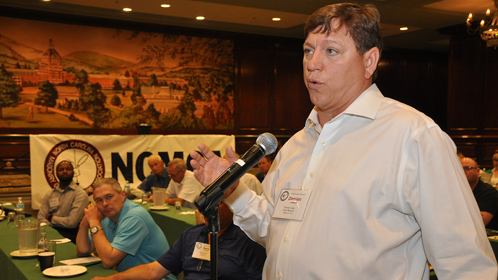 Damian Lang of Lang Masonry Contractors and EZ Grout Corp. asks a question of the panelists.