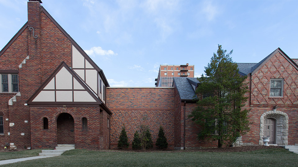 Three different colored bricks found in the original homes are blended in the new walls connecting the two neighboring properties.