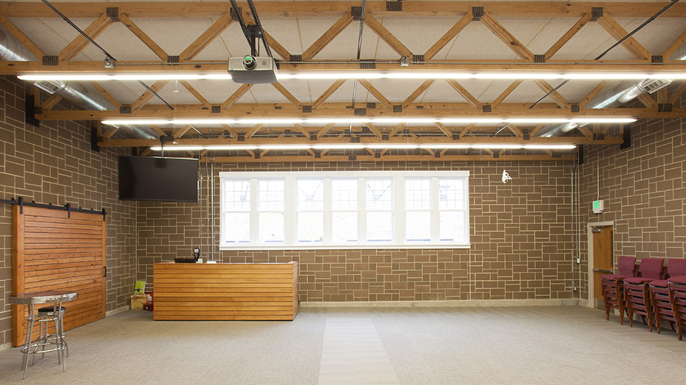 This dark charcoal block with light mortar set in an ashlar pattern was selected for the walls of the student center to mimic the limestone in the church.