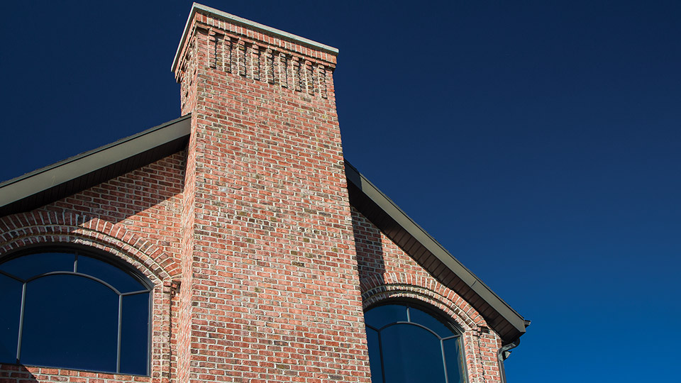 Flashing from the roof to the chimney is necessary to prevent water from leaking into the roof area where the chimney penetrates the roof.