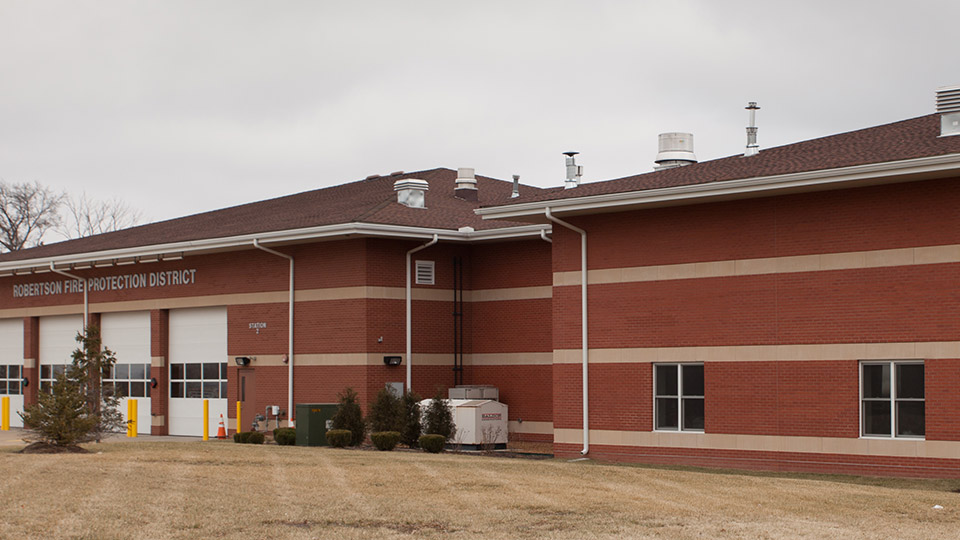 The new brick and cast stone addition of two equipment bays to the Robertson Firehouse blends seamlessly with the original building.