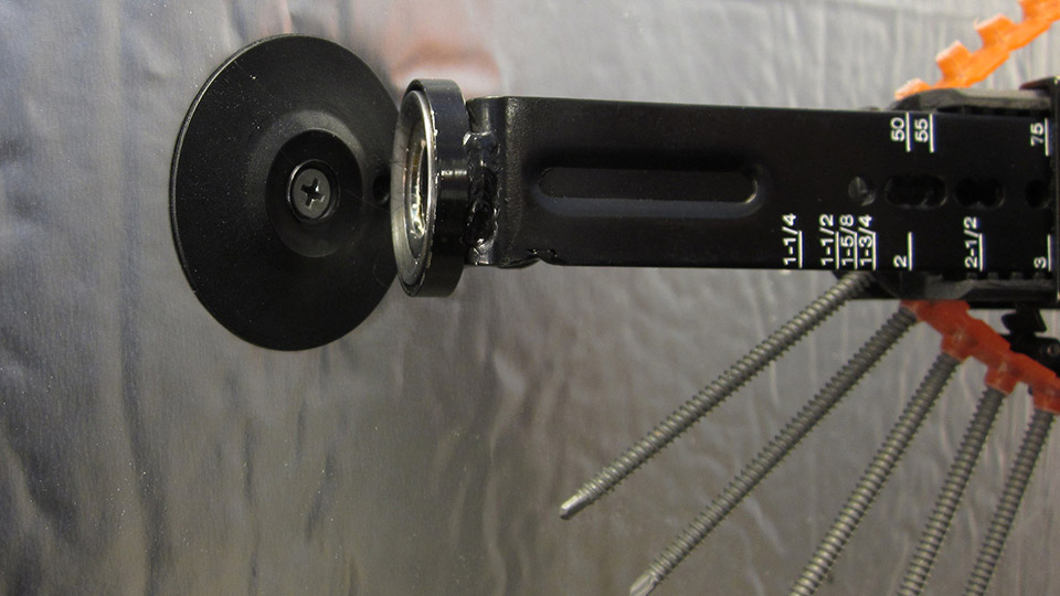 Air barrier sealing washer and screw attaching foil faced continuous insulation directly to steel studs with auto-feed screw gun.